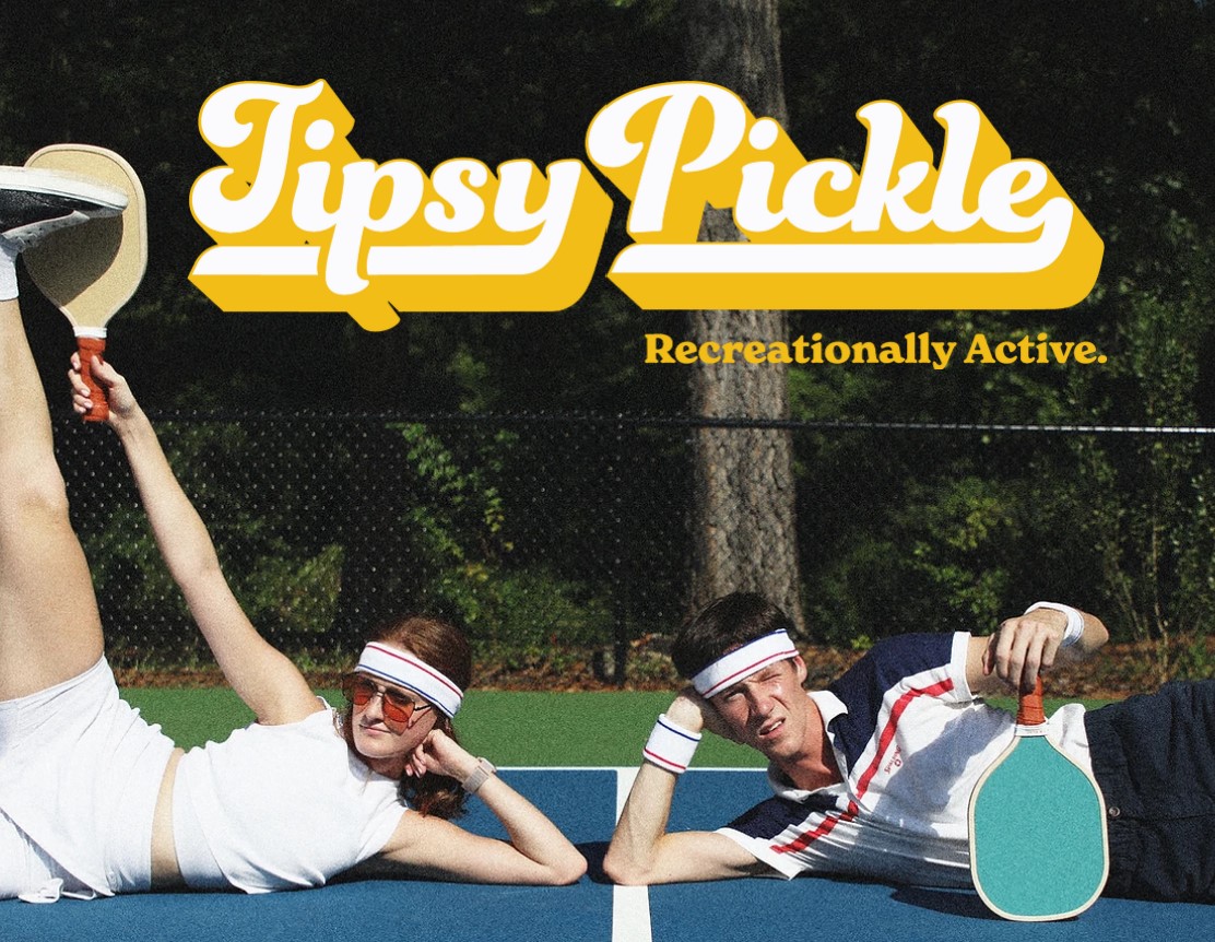 Tipsy Pickel graphic with guy and girl sitting on pickle ball court.