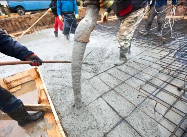 Guys Pouring Concrete at construction site