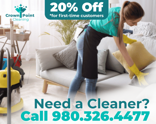 Crown Point Ad (1) Cleaner holding sponge and broom while on a job for Crown Point Cleaning.