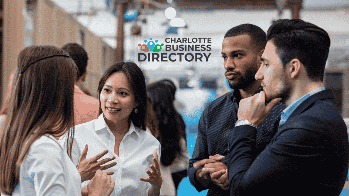 People standing at a networking event talking, with the Charlotte Business Directory logo centered in the middle.